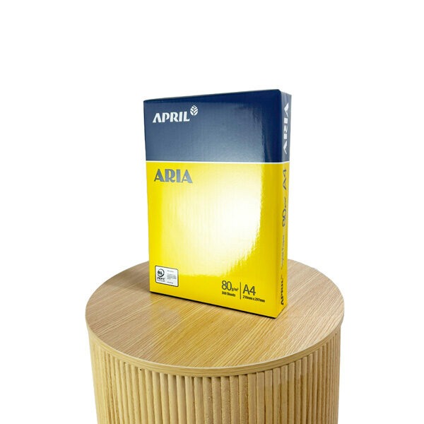 A picture of Aira 80gsm Copier paper ream of 500 sheets, in its yellow and navy blue packaging, standing up right on a display table.